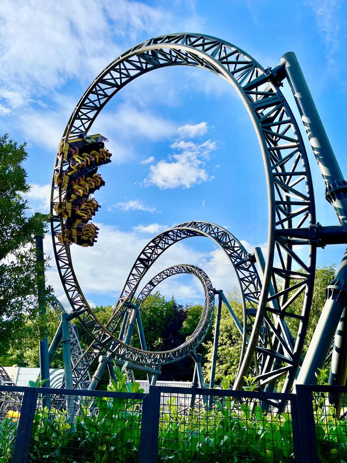 A thrilling roller coaster at Michigan's Adventure, surrounded by excited visitors.