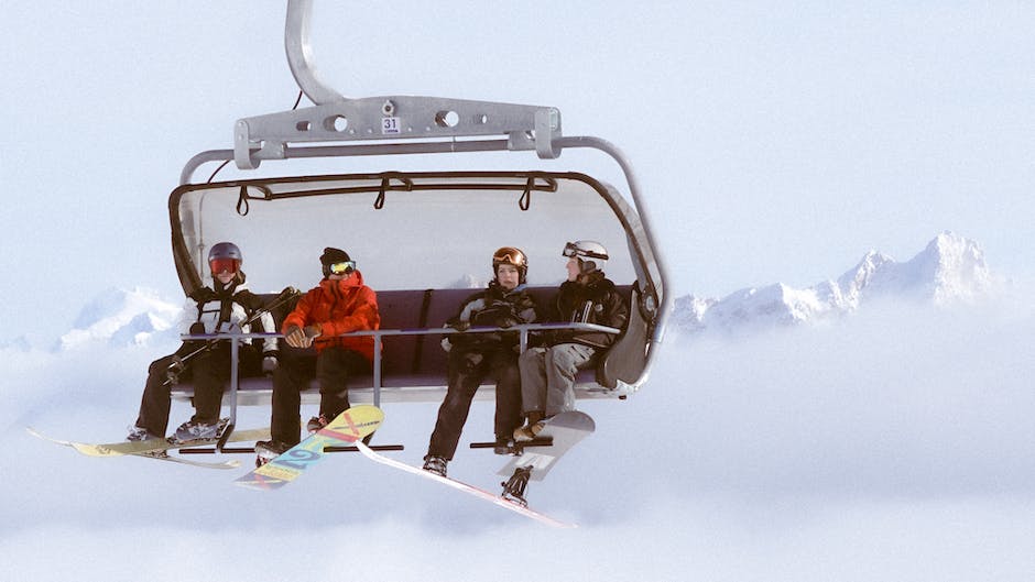 A group of people snowboarding and skiing in the snowy mountains of Michigan.