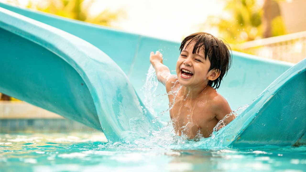 kid sliding down a water slide in michigan water park