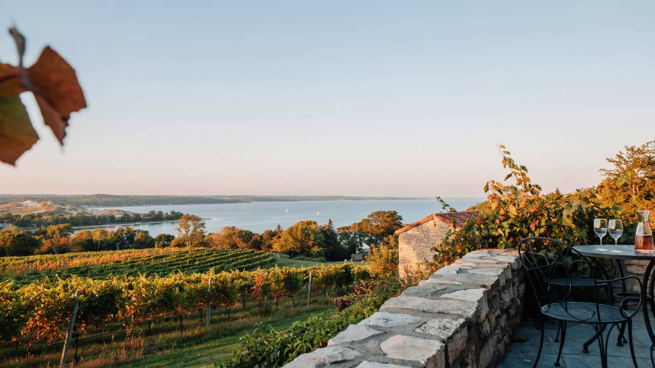 view of grand traverse bay and vineyards from an old mission peninsula winery patio
